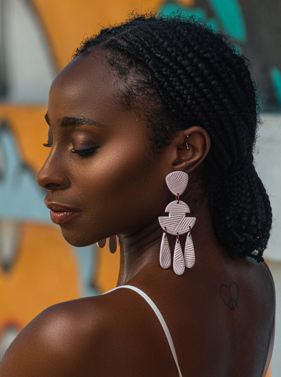 Uju Lwami Creations earrings on a model